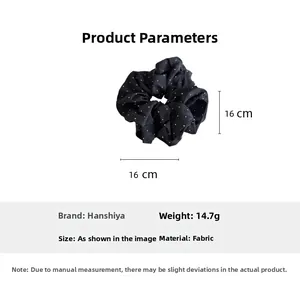 Detailed view of large black polka dot fabric scrunchie with 16cm size measurements