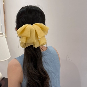 Yellow plaid tulle bow hair claw clip with crystal pendant shown on a low ponytail hair