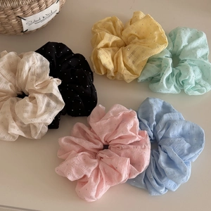 Detailed view of 6-piece rhinestone scrunchie set with checkered fabric texture
