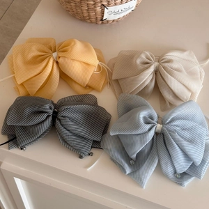 Detail of gingham ribbon hair claw clips with crystal pendant in four pastel colors