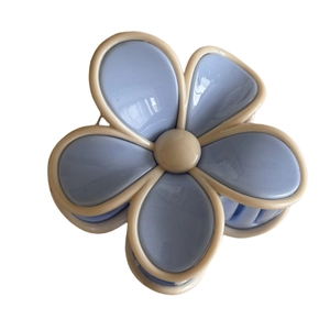 Minimalist light blue flower hair claw clip with beige border on white background