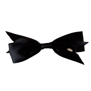 Elegant black satin bow hair clip with silver oval metal logo on a clean white background