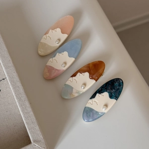 Minimalist oval profile hair clips with marble texture, pearl detail in four colors