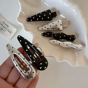 Set of 6 chic black and silver polka dot hair clips with classic duckbill design