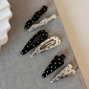 Polka dot hair clip set in silver and black featuring wave, drop, and triangle shapes