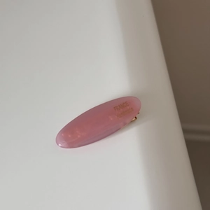 Close-up of a pink macaron acetate oval hair clip with gold France Handmade lettering