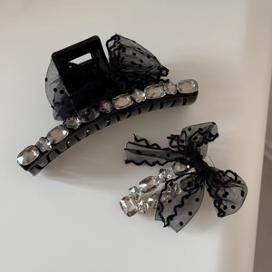 Detail of black polka dot mesh bow hair claw clips with sparkling rhinestones set