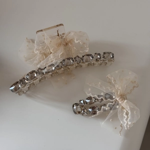 Detail of tulle bow hair claw with sparkling rhinestones and delicate lace texture