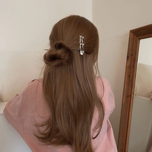 Silver bow wave hair clip worn on long brown hair, elegant metal hair accessory