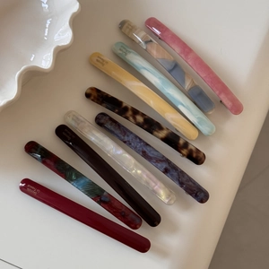 Close-up of assorted acetic acid barrettes with marble and tortoiseshell patterns