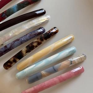 Detail showing various acetate barrettes with marble and tortoiseshell patterns