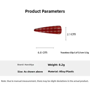 Macro view of a red and white checkered hair clip with dimensions of 6.8 cm by 2.1 cm