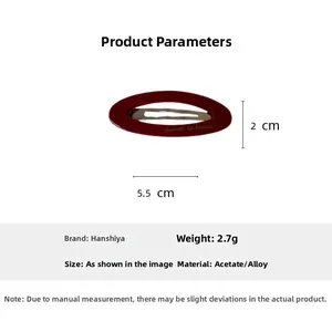 Macro view of red acetate oval hair clip with dimensions of 5.5cm by 2.0cm
