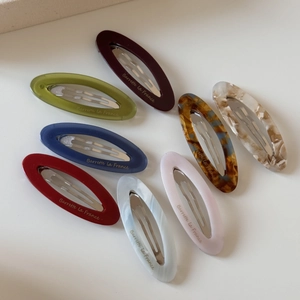 8-piece set of oval acetate hair clips in multiple marble colors with metal snap buttons