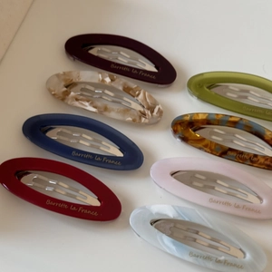 Oval acetate hair clips with marble patterns and Barrette La France lettering