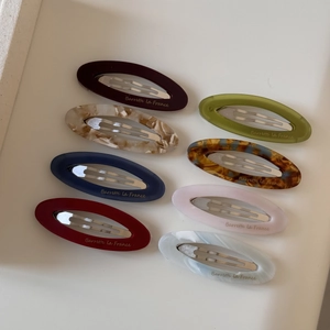 Set of eight oval acetate hair clips in assorted marble colors and tortoise patterns