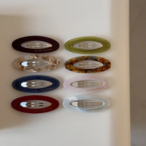 Set of 8 colorful acetate oval snap hair clips with elegant marble and tortoiseshell patterns
