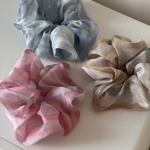 Three gradient tie-dye large hair scrunchies in pink, blue, and gold with silky texture