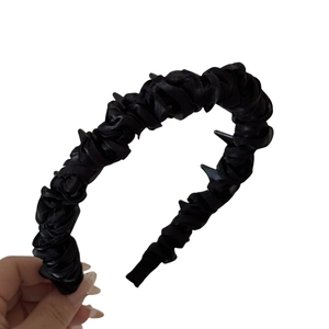 Chic black pleated fabric headband with decorative teeth design for a stylish hair accessory