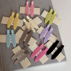 Set of 20 matte colorful metal duckbill hair clips neatly arranged on a card