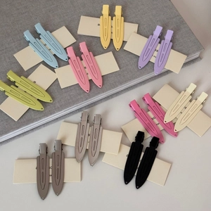 Detailed view of matte colorful leaf hairpins in assorted pastel shades on display card