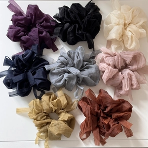 Close-up of pleated chiffon hair scrunchies in eight elegant vintage-style colors