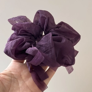 Close-up of deep purple puff chiffon hair scrunchie with soft pleated texture