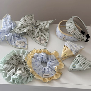 Detailed set of blue and green striped fabric hair accessories with heart prints