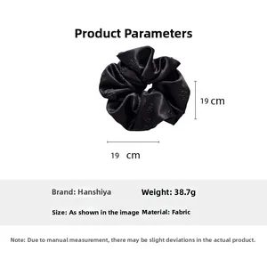 Detail view of large black satin hair scrunchie with rose embossed texture and size 19cm