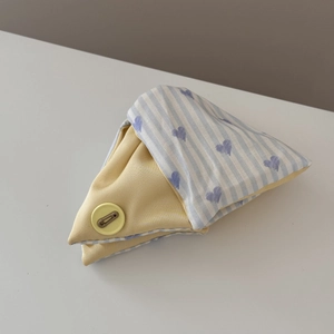 Detail of blue and white striped heart pattern pouch with yellow cotton fabric and button