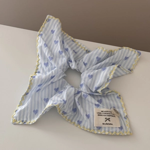 Detail of blue striped scrunchie with purple hearts and yellow scalloped edges