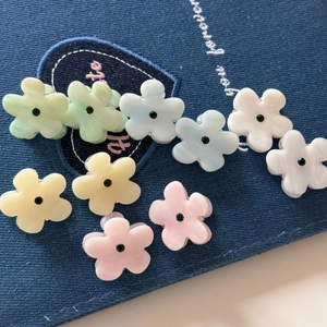 Floral mini hair clips set with embedded crystals on denim background for women