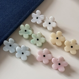 Flat lay of colorful resin flower mini hair clips with marble texture and rhinestone details