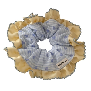 Blue striped heart pattern scrunchie with yellow ruffled edge and handmade label