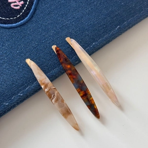 Three-piece French style acetate hair clips in tortoiseshell and pearl patterns