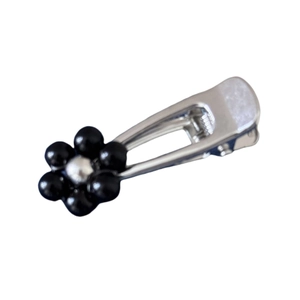 Silver metal floral hair clip with black and silver beads in a six-petal flower design