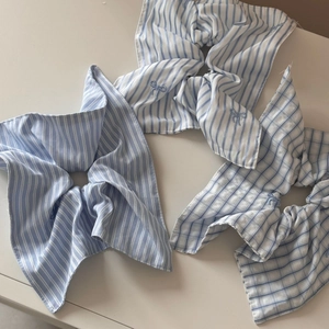 Blue and white striped scrunchies with embroidered bows and ruffled fabric design