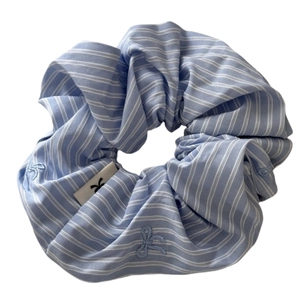 Blue striped scrunchie with embroidery and brand logo tag for hair styling