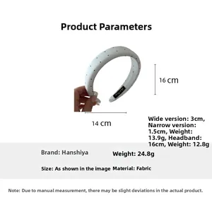 Detail showing white fabric headband with black polka dots in various sizes and dimensions