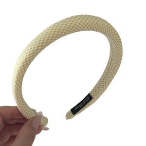 Yellow and white gingham check headband with elegant fabric texture and brand label