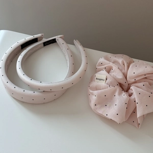 Detailed view of light pink polka dot headband set with matching soft scrunchie