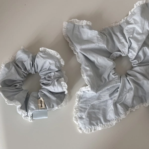 Light blue fabric scrunchies set with white lace trim and handmade label detail