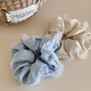 Elegant satin hair scrunchies with white lace edges in light blue and cream colors