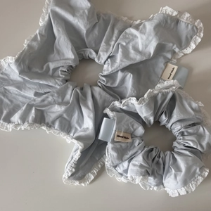 Set of light blue scrunchies with white lace edges and Hand Made label detail
