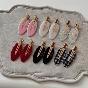 Set of 12 oval acetate hair clips in six colors with gold metal duckbill base