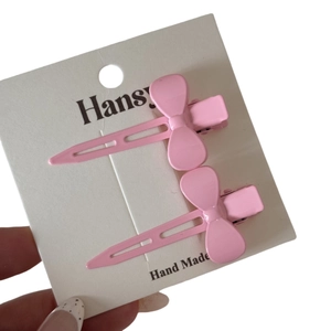 Lot de deux barrettes à cheveux nuds roses en métal pour frange, sur carte support