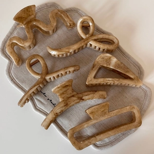 Set of six apricot marble texture claw clips in various geometric shapes for elegant styling