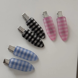 Detail of checkered resin hair clips with classic vintage patterns and metal grip