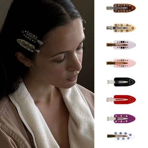 Detail view of assorted French acetate hair clips with marble patterns and rhinestones