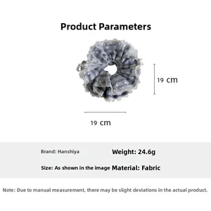 Detail view of blue plaid hair scrunchie with lace trim and specific size parameters